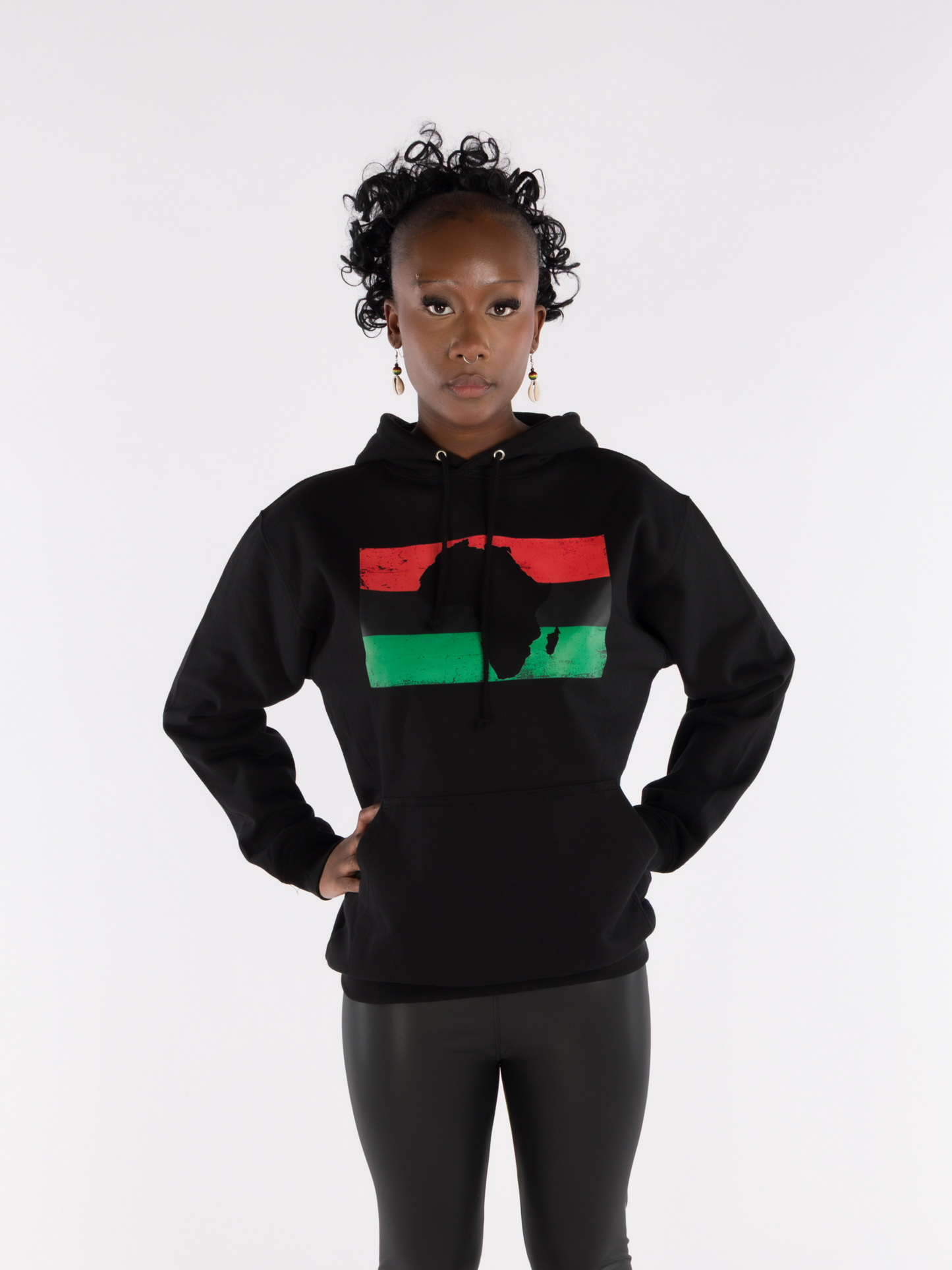 Woman wearing unisex black Afrocentric hoodie with Africa map and Pan-African flag colors red black green, cultural fashion.