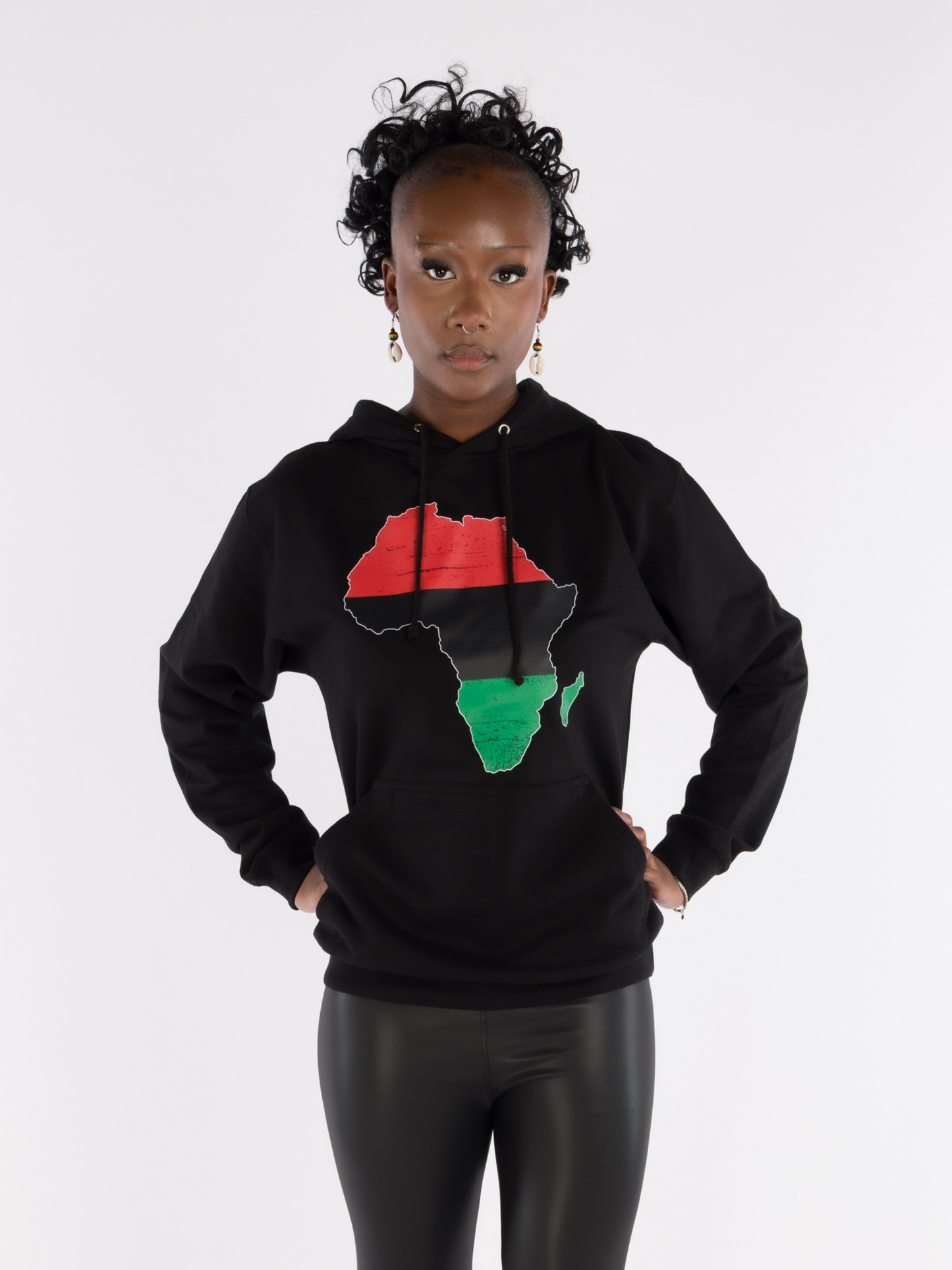 Woman wearing black Afrocentric hoodie with red, black, and green Africa map design, cultural streetwear Pan-African fashion.