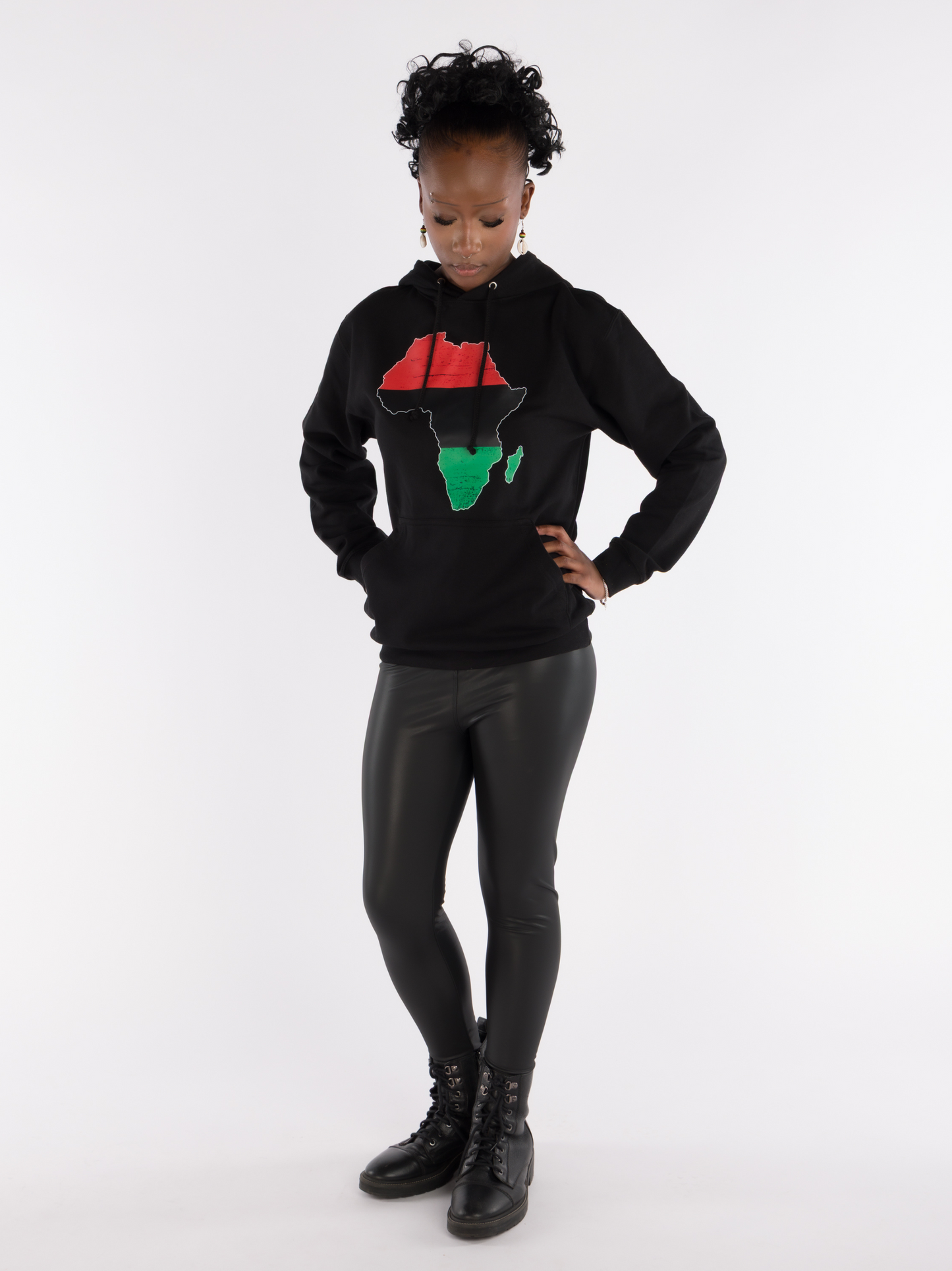 Full-body view of woman modeling black Afrocentric hoodie with Pan-African Africa map design, cultural fashion.