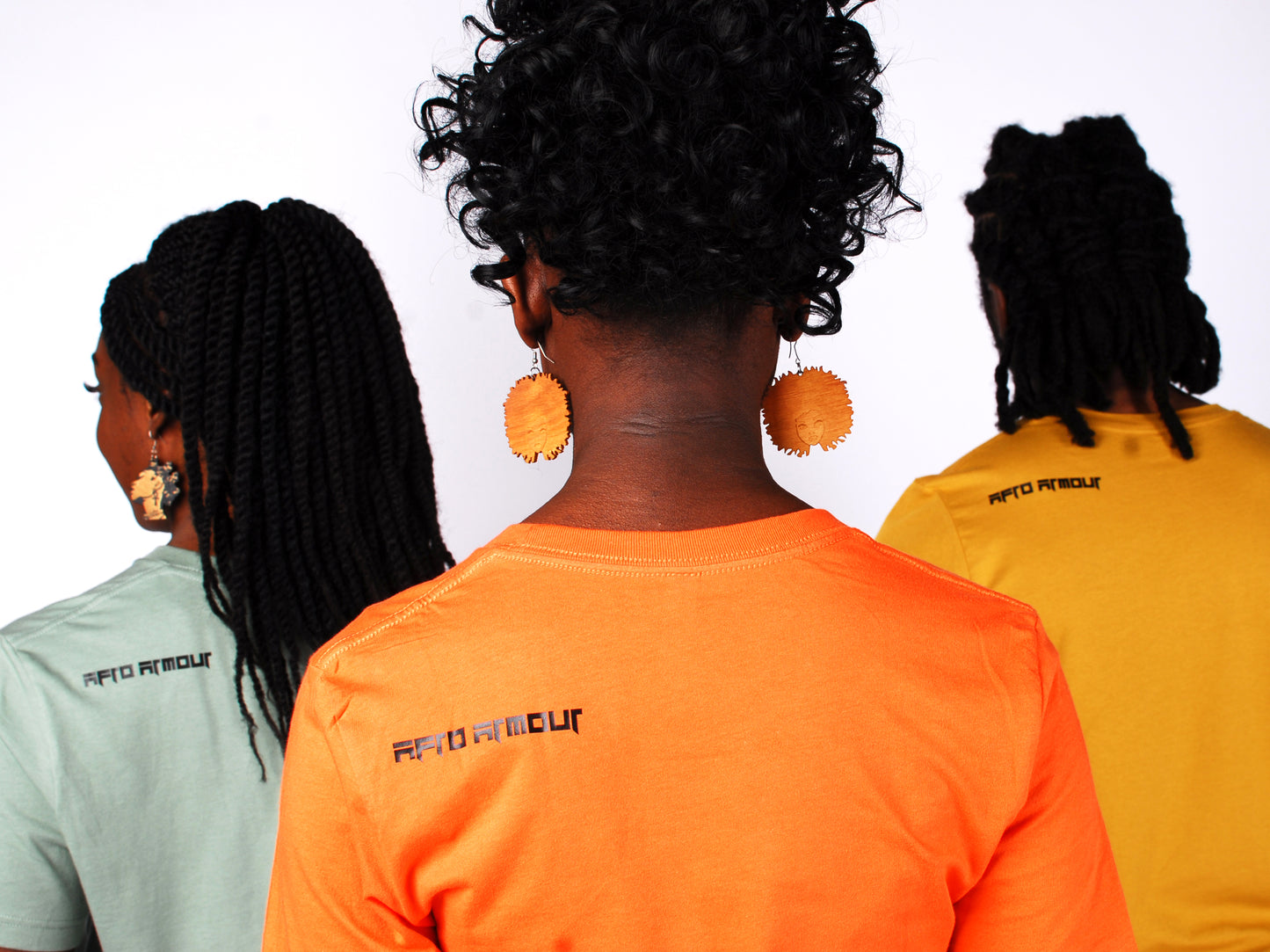Back of Afro Armour t-shirts in orange, green, and yellow showing brand logo across back, left shoulder.