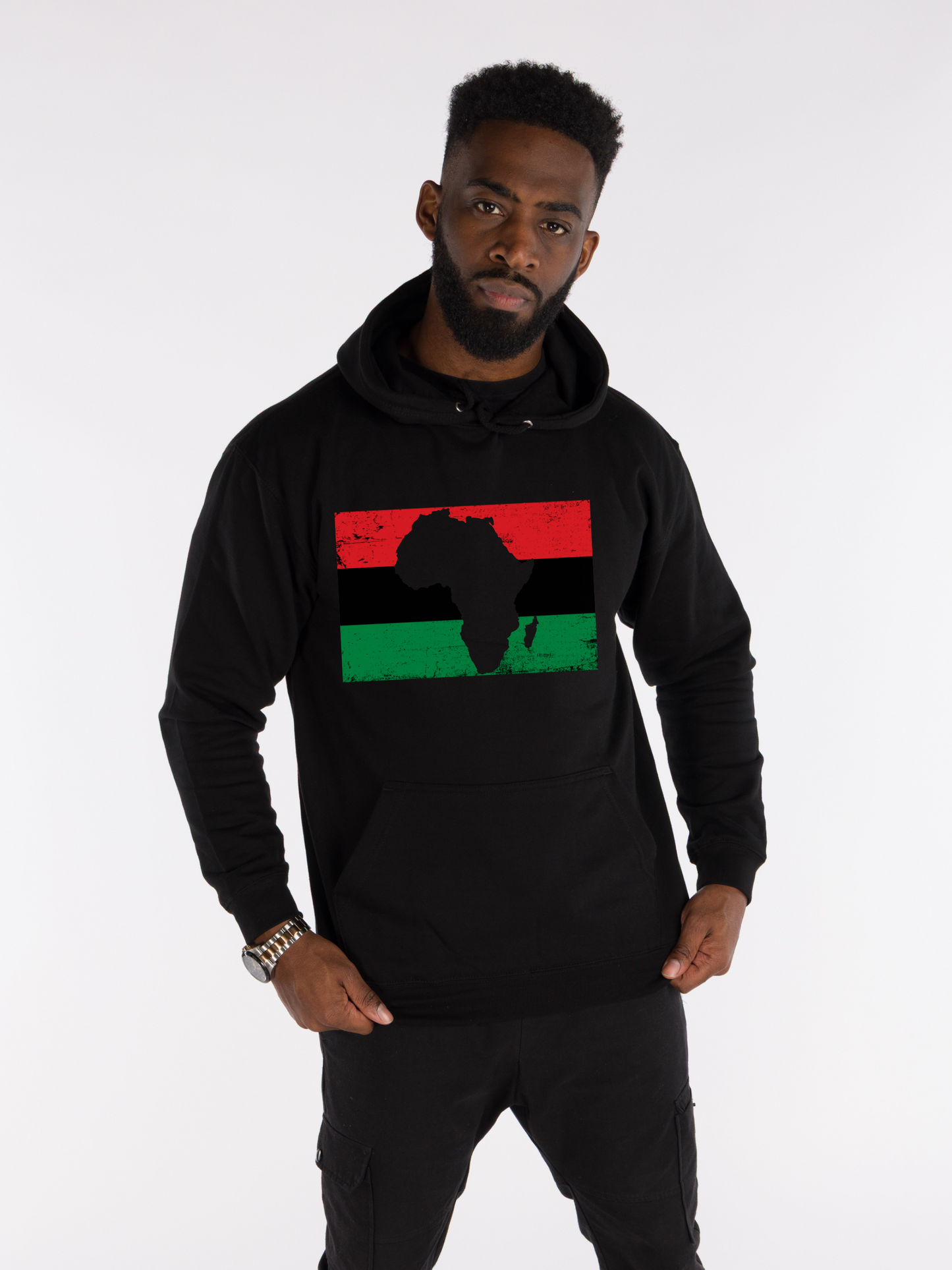 Man wearing unisex black hoodie with Pan-African red, black, and green flag design and Africa map silhouette, Afrocentric streetwear.