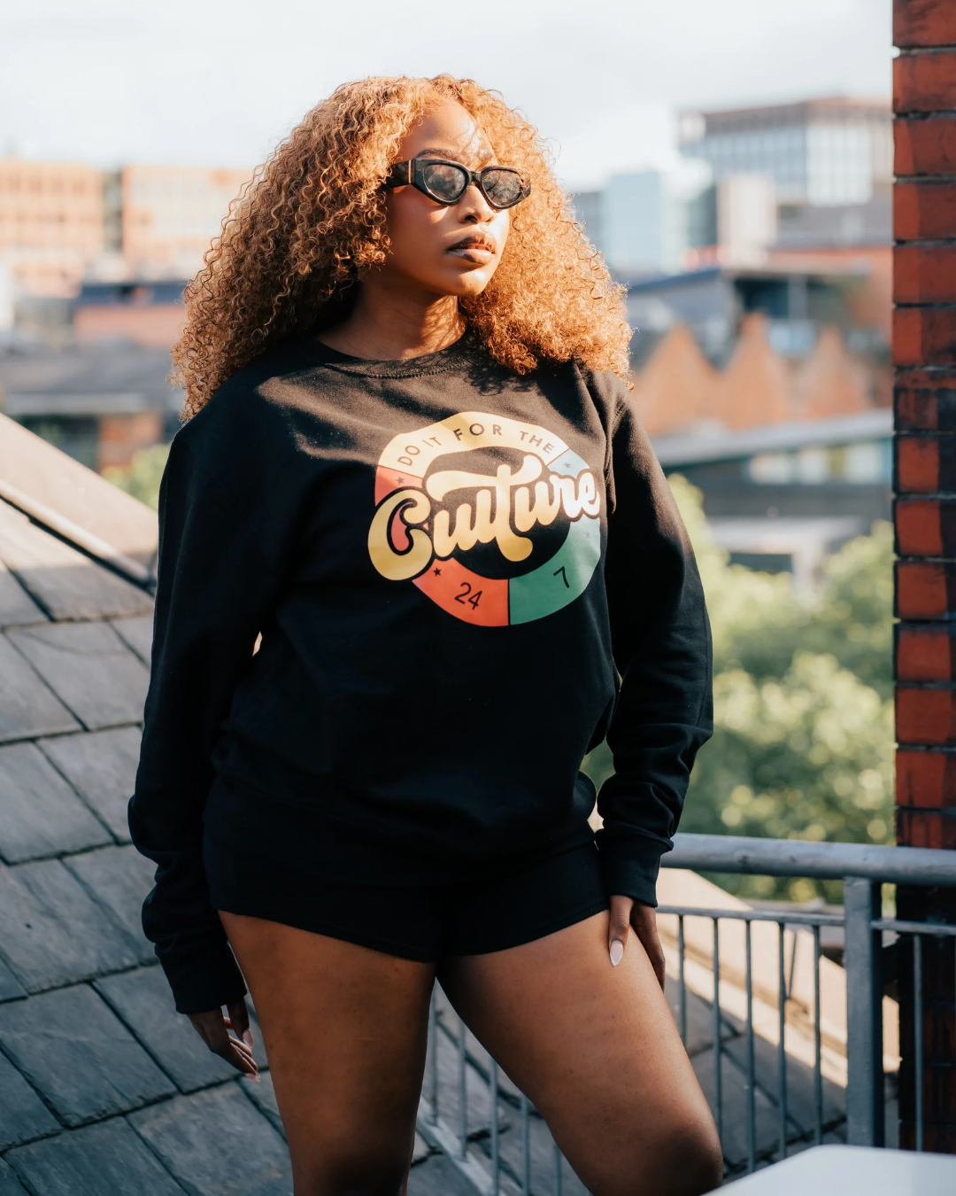 Women’s black sweatshirt with colorful 'Do It For The Culture' graphic design, casual streetwear style.