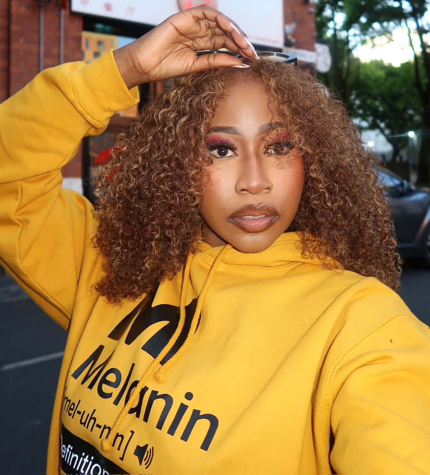 Women’s mustard yellow Melanin definition hoodie with bold black graphic print, casual streetwear pullover.